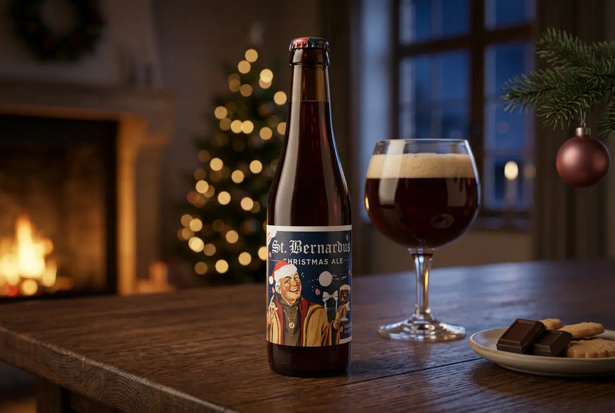 St. Bernardus Christmas Ale bottle with glass on a wooden table, holiday decorations in a cozy setting.